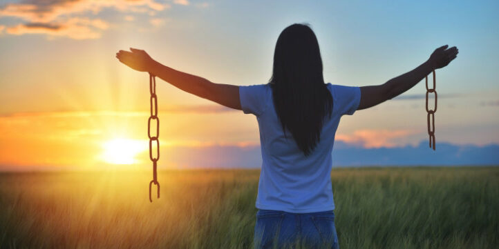 Girl extending arms, she broke the chains binding her arms.